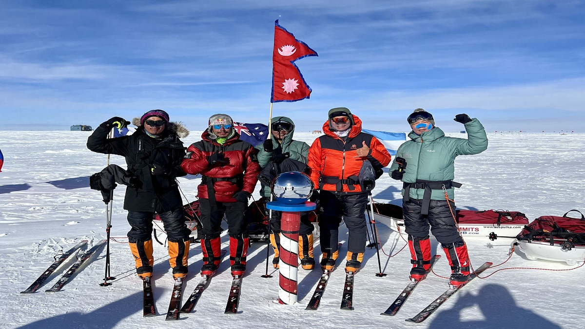 Nims and the team wave first Nepali flag on South Pole